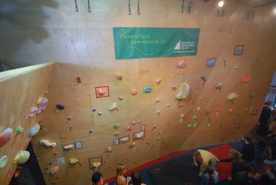 One of the walls at the gym filled with problems