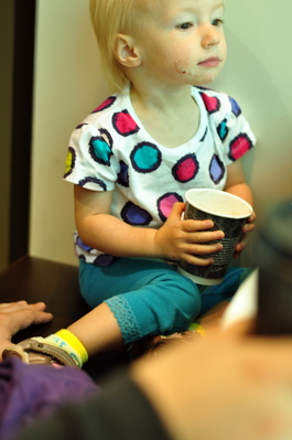 Kiera watching the planes and enjoying a babychino before my flight