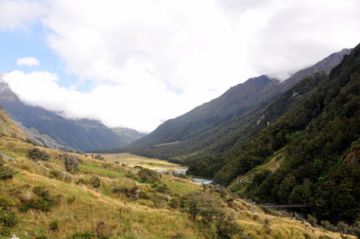 Tiny footbridge over the river among the hills and valleys