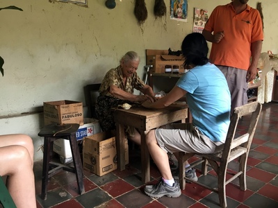 Evelyn rolling a cigar
