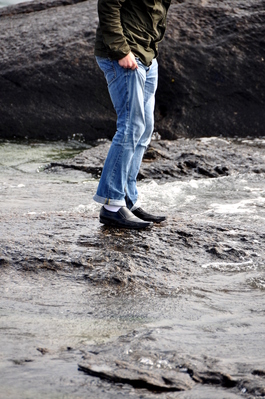 Anthony trying to keep dry as he ponders whether to try to make the leap to the next rock