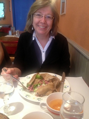Mom and her galette with a mug of cider
