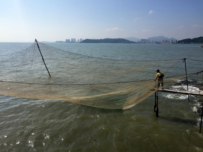 Guy fishing beside the lunch restaurant