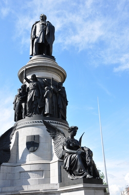 Spire of Dublin behind a statue at the foot of O'Connell Street