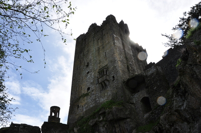 Blarney Castle with the sun glowing behind it