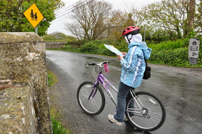 Kim on her bike examining the map