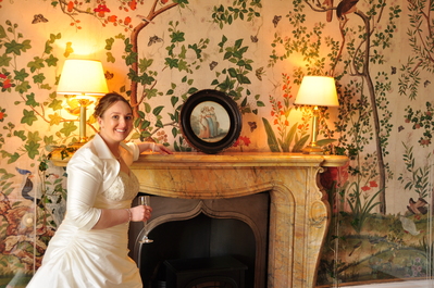 Toni against some of the castle's hand painted wallpaper