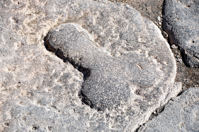 Carved into the street to point the way to the brothel