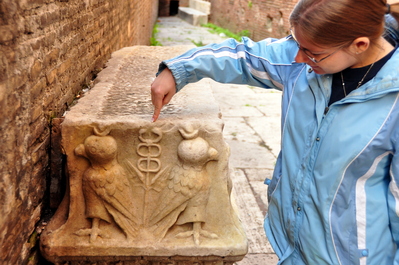 Kim pointing at a carved stone at The Pantheon