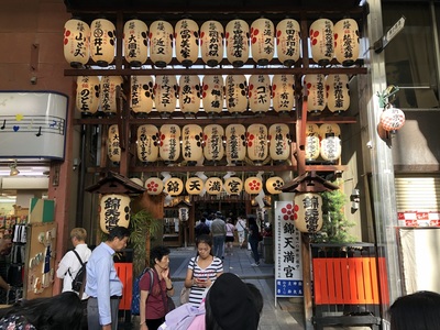 Random shrine in the middle of a busy shopping district