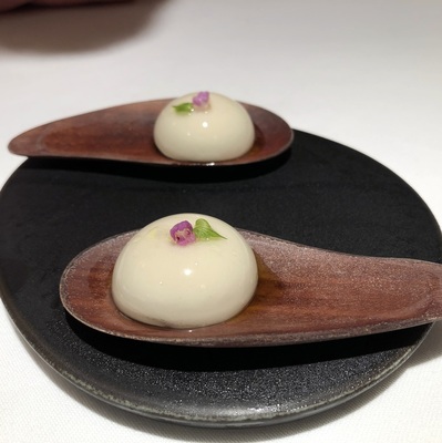 A small chocolate filled sweet served on a wooden spoon