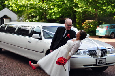 Newly weds in front of the limo